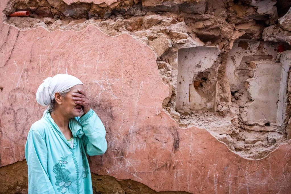 A woman reacts standing in front of her earthquake-damaged house in the old city in Marrakesh. Photo: Fadel Senna/AFP via Getty Images