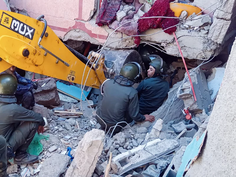 Rescue workers search for survivors in a collapsed house in Moulay Brahim, in Morocco's