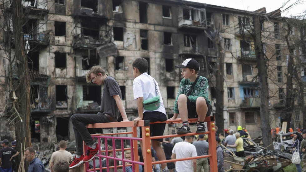 Children at the scene of a Russian rocket attack that damaged a multi-storey apartment building in Kryvyi Rih, Ukraine, on June 13, 2023.